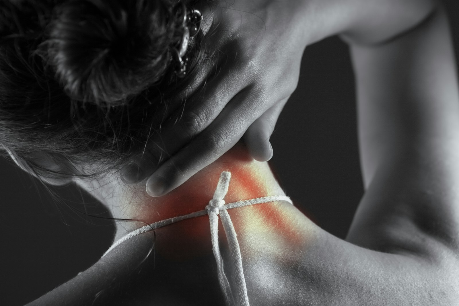 Person holding a sore neck