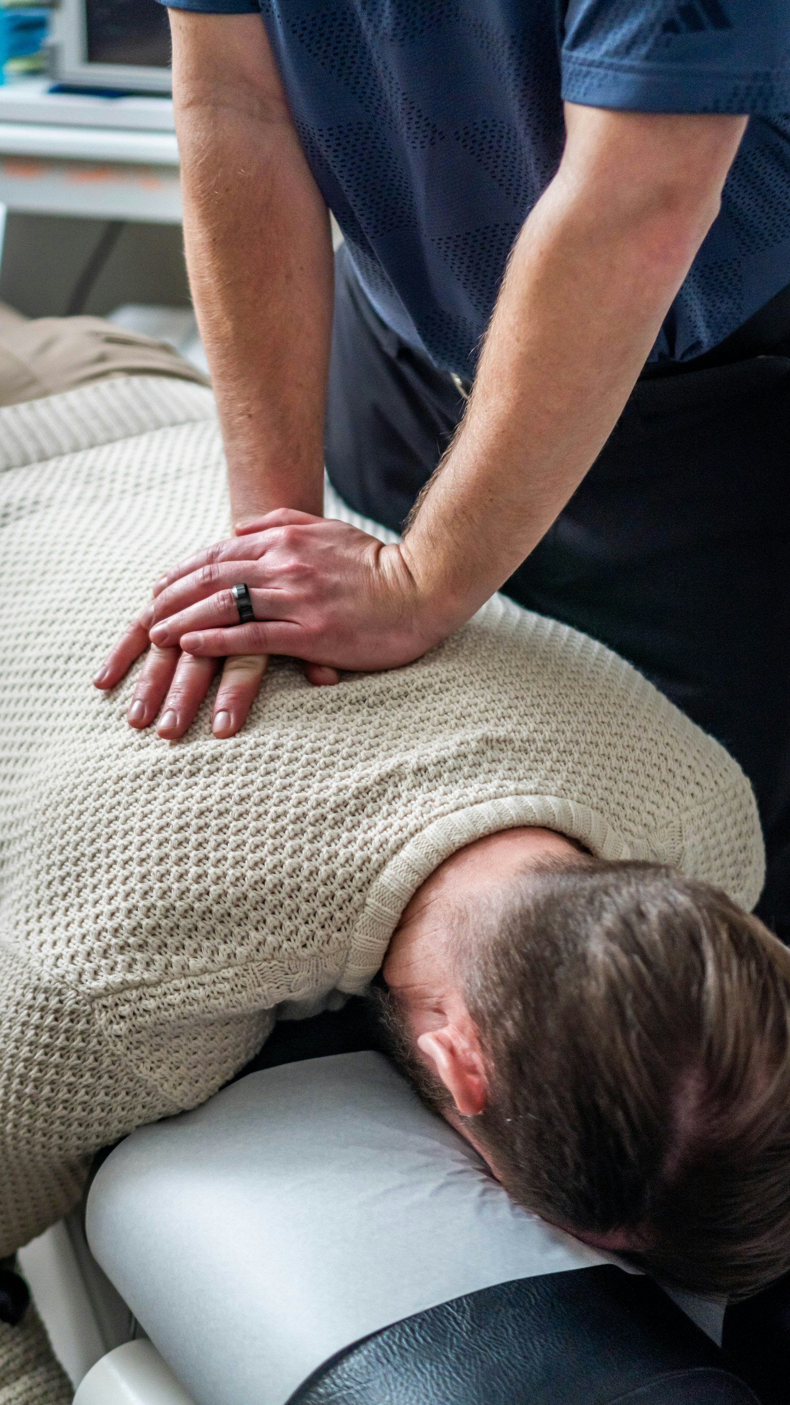 Chiropractor treating a patient's upper back