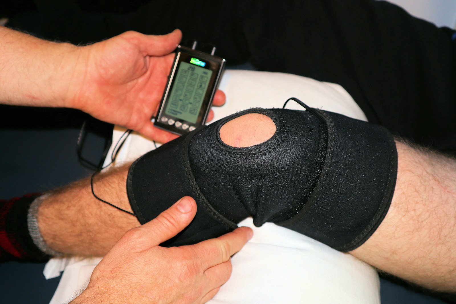 TENS pain-relief unit on a knee