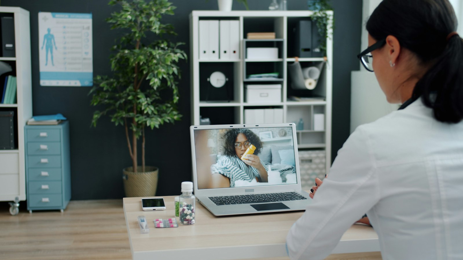 Doctor speaking with a patient by laptop video call
